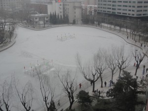 The lake outside our place in Beijing was frozen over, but people were still out walking.
