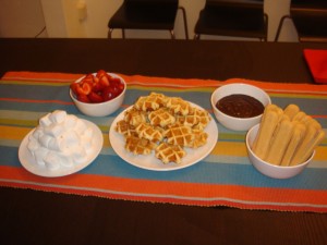 Belgian waffles, strawberries, marshmallows, and cookie sticks with dark chocolate bath.
