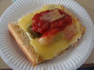 toasted bread with cheese, tomato, and pesto