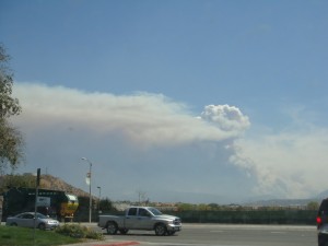 Wildfire smoke battles fluffy cloud.