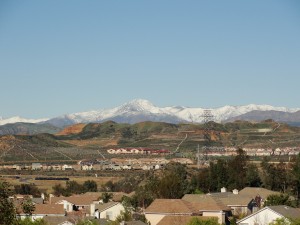green hills with snowy mountain range as backdrop