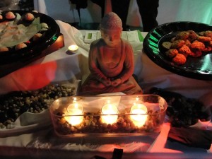 serene scene of mini buddha statue in candlelight