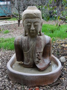 buddha statue sitting outside yoga studio