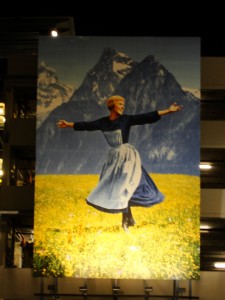 a huge painting of a scene from the Sound of Music adorns the side of a parking structure