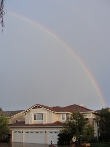 rainbow arching over houses