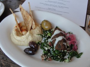 falafel, tabbouleh with quinoa, garlic hummus with chickpeas, crackers, and olives at m cafe