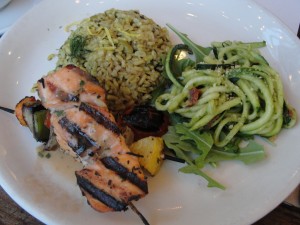 salmon on a skewer, zucchini noodles and rocket lettuce, brown rice pilaf at m cafe