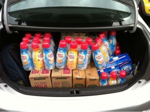 trunk filled with cases of creamer, milk, and other food