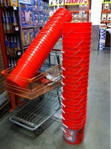 two huge stacks of orange 5-gallon buckets