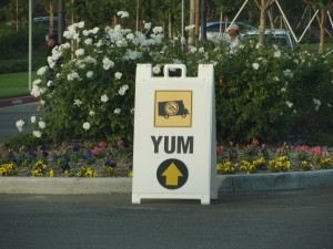 sign saying "yum" with image of food truck