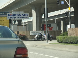 cops on motorcycles exiting cargo area near LAX
