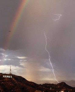 picture of rainbow, lightning, and helicopter over hollywood sign