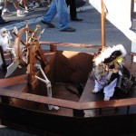 dog dressed as pirate on wooden pirate ship float for haute dog parade 2010
