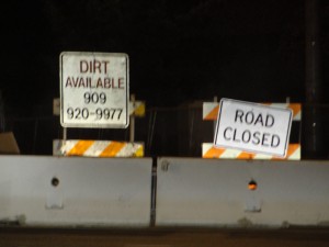 "dirt available" sign with phone number for prospective buyers