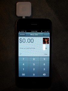 square device plugged into iphone with square app running