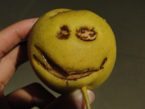 pear with smiley face bitten into it