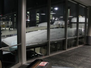 snow piling up outside window at jfk airport