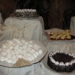 plate of marshmallows, two cakes, and plate of desserts