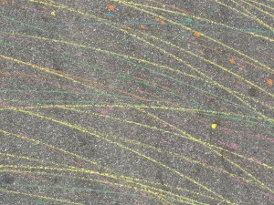 thin colorful chalk marks on pavement made by bike with contrail device
