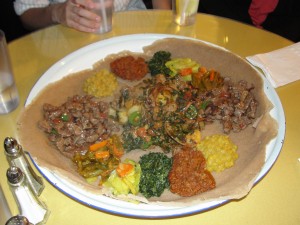 tray of ethiopian food with veggies and tibs