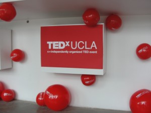 tedxucla entrance with signs and beach balls strewn around