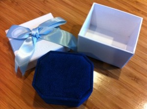 white outer box with ribbon and fuzzy blue inner box