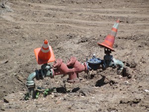 two cones on top of some pipes coming out from the ground in a construction zone at ucla