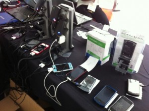 a dozen cell phones being charged at the igo-sponsored charging station at opportunity green
