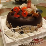 fish-shaped cake cutter and chocolate cake with red candles
