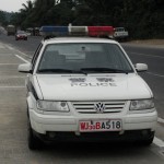 chinese police car parked on side of road