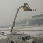 plane getting sprayed by de-icing fluid before takeoff