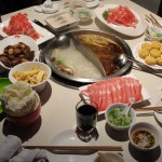 hot pot table with items ready to be thrown in