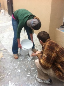 pouring paint into small cups at habitat for humanity house