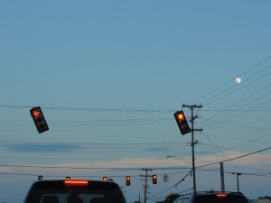 two hanging signal lights blown crooked by a windy storm