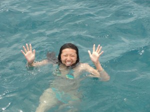 waving while floating in ocean after jumping in
