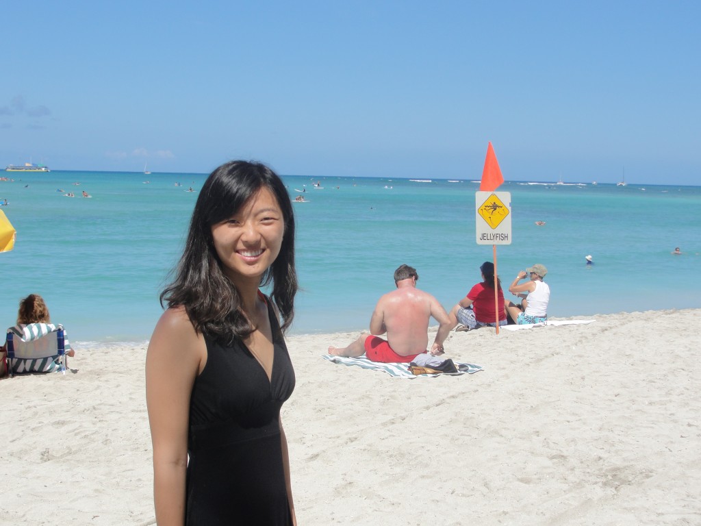 posing with jellyfish warning sign at waikiki beach
