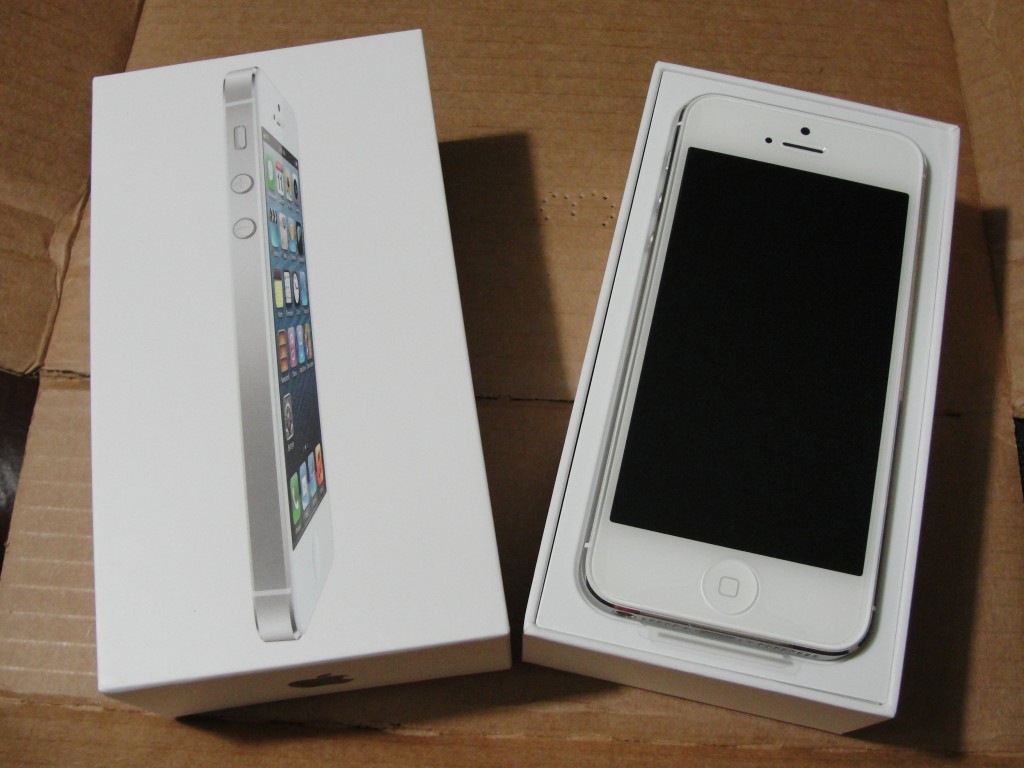 box of white & silver iphone 5 open to reveal phone inside