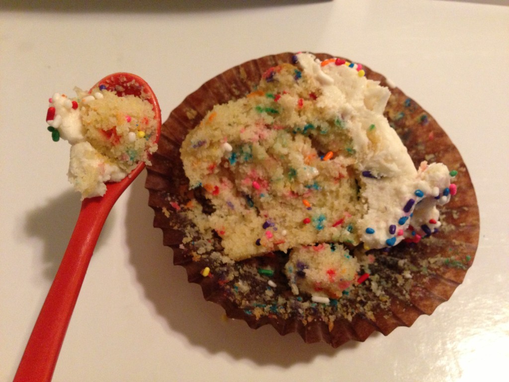 spoonful and half-eaten magic mountain confetti cupcake with sprinkles from bake you happy in valencia