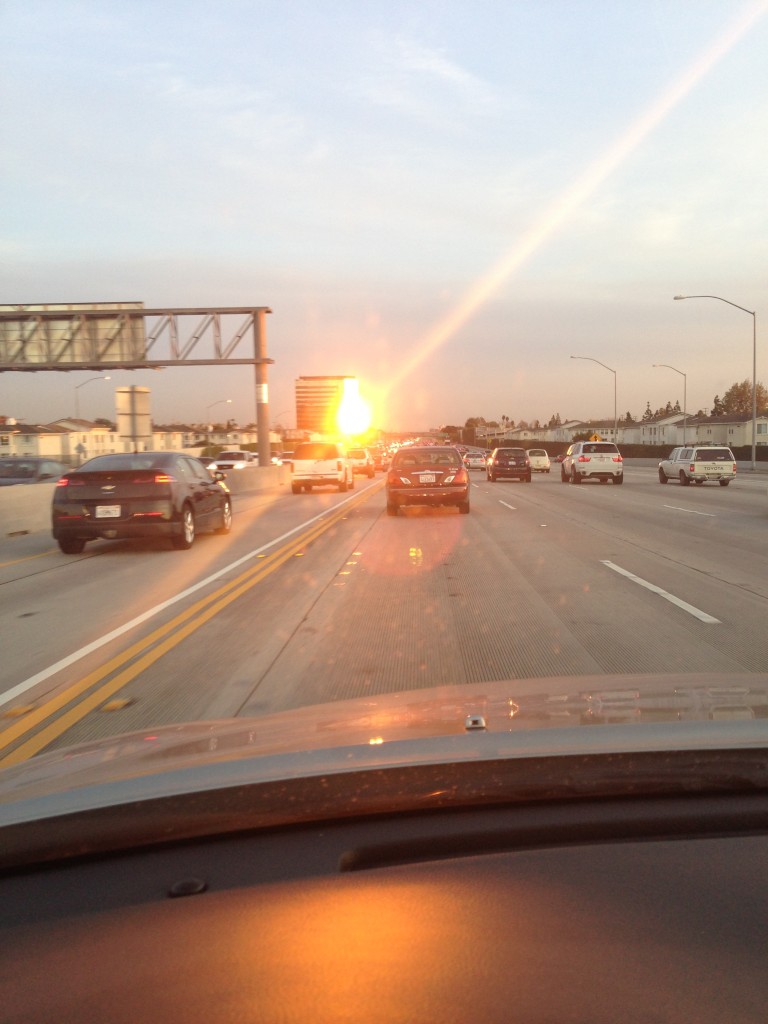 reflection of setting sun creating bright glare for drivers on 405 freeway