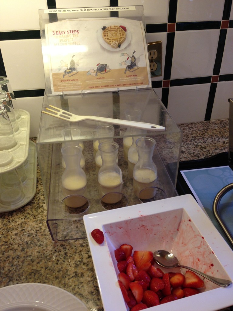 waffle batter portions in individual cups and strawberry slices