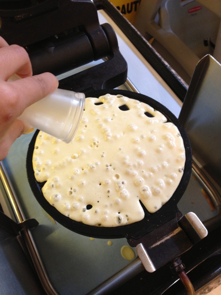 pouring waffle batter into waffle maker