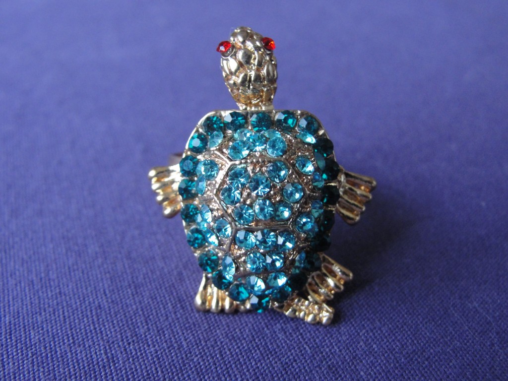 metal turtle ring with blue gems and red eyes