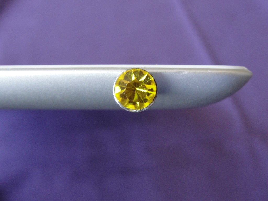shiny yellow gem metal phone jack dust plug