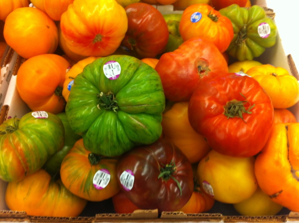 colorful heirloom tomatoes ranging from green to red to yellow to orange at ralph's grocery store