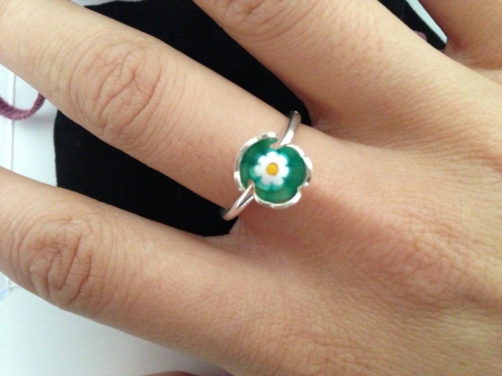 wearing tous bear green & white flower ring on finger