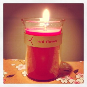 lit red flower candle in italian blood orange scent