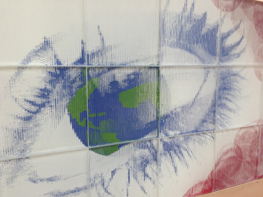 holographic image of eye with earth as iris on wall of california science center