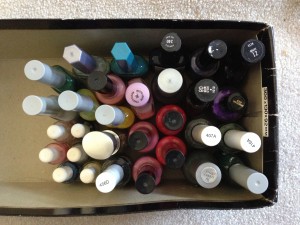 collection of nail polishes in shoebox top view