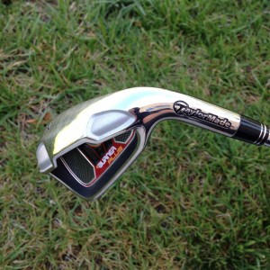 taylormade 7 iron golf club head with background of grass