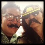 guy and girl wearing mustache glasses